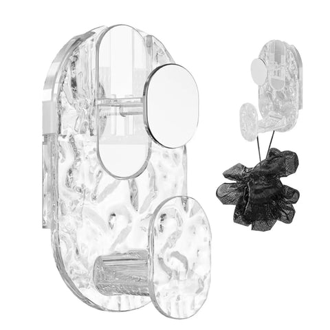 Grippy Wall Mount Hook With Heavy Duty Adhesive Strip No Stress Drilling Required holds a black loofah near a transparent wall mount on tile.