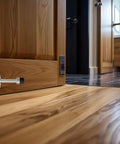 Zero Hassle Wall Mount Door Stopper, Straight Up Self Adhesive Tape Or Screw Grip, Brushed Stainless Steel Frame With Thick Rubber Bumper, Pack Of 2 Sweet Wall Protectors For Any Interior Door mounted on wooden door near floor.