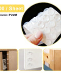 Clear self adhesive cabinet door bumpers 6mm diameter 2mm thick noise reducing non skid cushions pack of 100 visible in use.