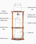 Portable Cold Brew Drip Tower And Adjustable Iced Coffee Maker Featuring Removable Filter For Smooth Extraction with glass and wood parts.