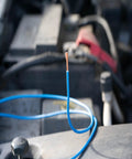 Heavy Duty 14 Gauge Primary Wire On A 100 Feet Black Spool With PVC Jacket Water Oil Chemical And Abrasion Resistant Ideal For Cars Trucks Boats And Auto Wiring DIY Projects depicted in an automotive setting