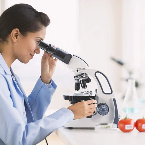 Scientist using the SW380B 40X-2500X Magnification Pro-Grade Binocular Lab Microscope for research in a laboratory setting.