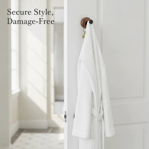 Kickass Single Wall Hook Built With Rock Solid Aluminum And Rich Black Walnut Wood For Hanging Heavy Winter Coats Bath Towels Backpacks And Daily Essentials In Entryways Or Bathrooms with a white robe hanging on it.