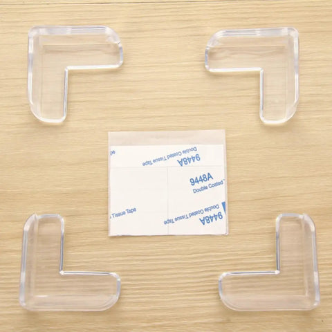 White PVC Corner Protectors For Tables And Cabinets, Heavy Duty Adhesive Edge Guards, shown with adhesive tape on wood background.