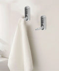No Sweat Foldable Invisible Wall Hooks Zinc Alloy Storage Hangers 4 Pack mounted with a white towel in a bathroom setting.