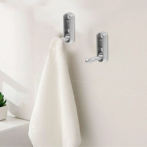 No Sweat Foldable Invisible Wall Hooks Zinc Alloy Storage Hangers 4 Pack mounted with a white towel in a bathroom setting.