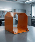 Heavy Duty Grey Foot Switch Guard Cover With Angled Hooded Shape And Textured Coating For Tight Machine Shop Spaces Durable Hardware Accessory, orange color, showing angled design.