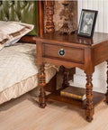 Bedside table with Six Piece Antique Brass Drawer Ring Pull Handle installed, showcasing classic vintage style in elegant retro floral design.