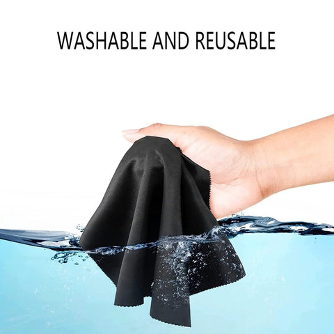 Black microfiber glasses cleaning cloth being washed under water; washable and reusable.