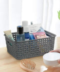 Pack Of Six Gray Plastic Storage Baskets, Durable Stackable Organizer Bins, 10.03 In By 7.59 In By 4.09 In, filled with toiletries