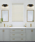 2 Light Vanity Light Fixture Black and Gold With Clear Glass Shade Matte Black Finish Brushed Gold Copper Accent Socket in bathroom.