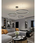 Spacious Circle Pendant Light Built With Heavy Duty Aluminum And Offering Hella Bright White Glow Smooth Rust Proof Finish Great For Large Dining Rooms Kitchens Or Open Lofts Serving Up Top Tier Daily Illumination in modern living room setting.