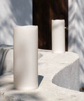 Huge Outdoor Flameless LED Pillar Candles 4X10 Inches IP44 Waterproof With Remote And Timer on a patio wall in daylight
