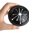 Hand holding a black rubber splash guard from Four Pack Garbage Disposal Splash Guards And Stopper Set For Three And One Eighth Inch Drains.