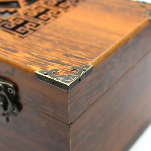 Iron Corner Protectors For Boxes And Drawers, Triangle Carved Guard In Bronze Retro Vibe mounted on a wooden box corner