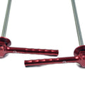Close-up of red OMNI Racer World quick-release wheel skewers, 2-pack, aluminum, 41 g total, outdoors