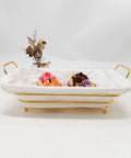 Gold Wire Serving Basket For Fruit And Bread with linen liner, filled with colorful cupcakes on a white countertop.