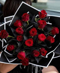 Bouquet wrapped in waterproof black and white floral wrapping paper sheets 22.83 inch square for gift packaging.