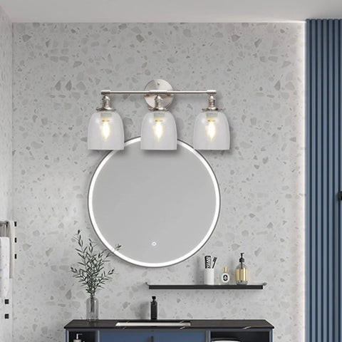 Bathroom vanity with three light fixture featuring Four Pack Clear Seeded Glass Lamp Shade Replacements For Ceiling Fans Chandeliers Pendant Lights Vanity Lights And Kitchen Island Fixtures Fits Two And One Eighth Inch Fitter 4.76 Inch Diameter 5.47 Inch High mounted above round mirror on terrazzo wall.