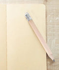 Single short wooden pencil with HB graphite and white eraser on notebook, part of 60 Pcs Mini Wooden Pencils With HB Graphite And White Erasers.