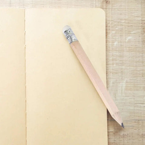 Single short wooden pencil with HB graphite and white eraser on notebook, part of 60 Pcs Mini Wooden Pencils With HB Graphite And White Erasers.
