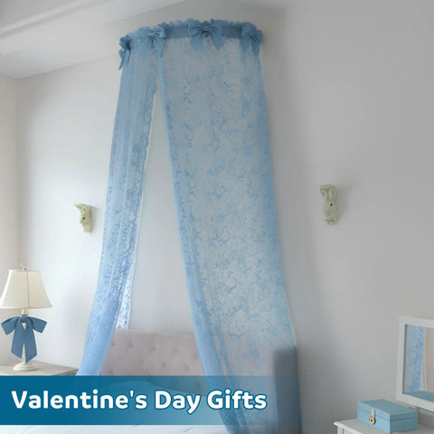 Rod pocket curtains in light blue draping over a metal bed canopy frame, suitable for any bedroom setup.