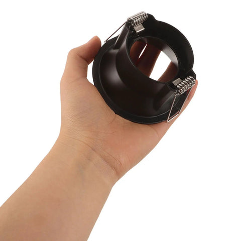 Operitacx Black Metal MR16 Downlight Housing, Fits 1.57" Cut-Out, 3.3" OD, hand holding the black recessed spotlight trim.
