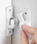 Matte White Aluminum Barn Door Latch Heavy Duty Gate Lock being installed on a door with finger pressing the lock.