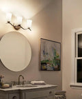 Three Light Vanity Light In Brushed Nickel With Satin Etched White Glass 23 Inch Wide Bath Lighting Above a Modern Bathroom Mirror