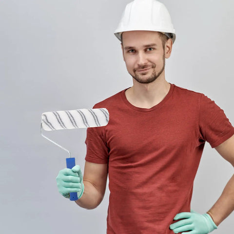 Lightweight Small Paint Roller With Ergonomic Handle For Fast Wall Coverage And Crisp Clean Edges Ideal For Ceilings Trim And Furniture Zero Drip Formula Makes Every Painting Job A Total Breeze held by a man in a hard hat.