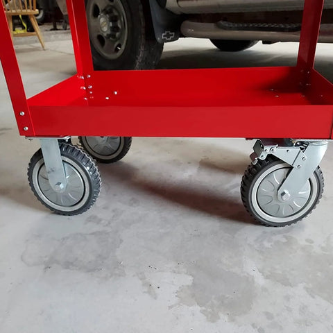 Set of four 6-inch heavy-duty swivel caster wheels on a red cart frame; gray wheels with braking mechanism.
