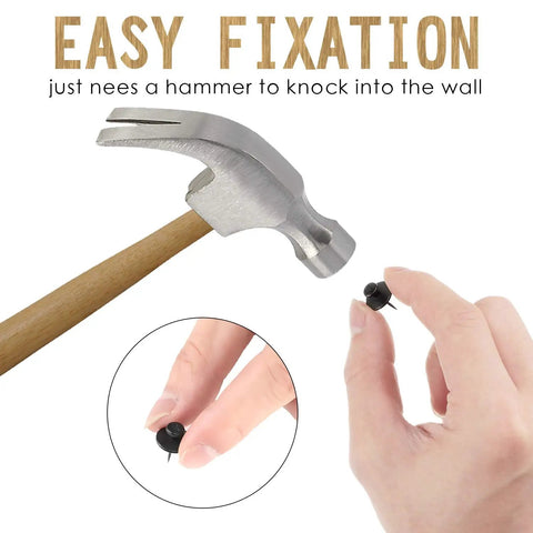 Holding Double Headed Push Pins For Picture Hanging And Photo Decor near a hammer, showing easy fixation.