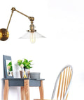 Wall Sconce Lights Indoor Bedroom Hallway Swing Arm Lamps with Switch,Adjustable Metal,Clear Glass Shade,Hardwired Industrial Lamp for Living Room, mounted above a small desk.