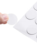 Close-up of a white self adhesive screw hole sticker from the 580 Pcs Self Adhesive Screw Hole Stickers Six Pack White Caps.