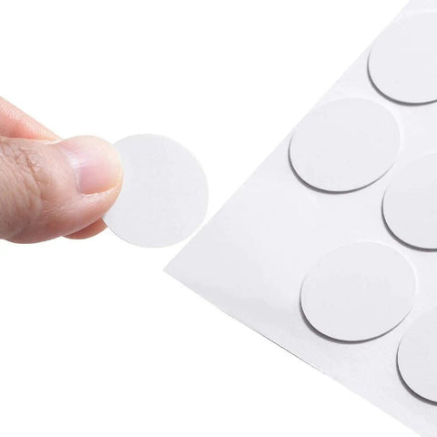 Close-up of a white self adhesive screw hole sticker from the 580 Pcs Self Adhesive Screw Hole Stickers Six Pack White Caps.
