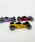 Three Pack 1/64 Scale Race Cars For High Speed Track Action On 1/64 Scale Tracks Compatible With Popular Racing Sets Great Gift For Kids And Collectors Seeking Fast Fun. Yellow, red, and purple cars on white background