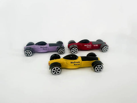 Three Pack 1/64 Scale Race Cars For High Speed Track Action On 1/64 Scale Tracks Compatible With Popular Racing Sets Great Gift For Kids And Collectors Seeking Fast Fun. Yellow, red, and purple cars on white background