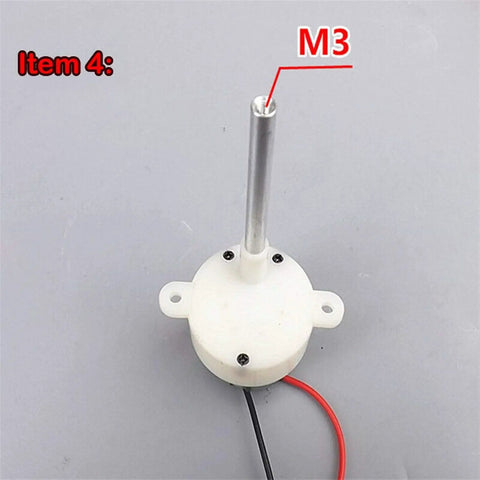 Top view of DC Gear Motor 3-9V Slow Speed 2.5-11 RPM, white plastic gearbox housing with metal shaft marked M3, wires attached