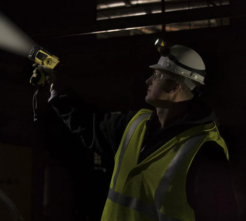 Man using Waypoint Beefy 500 Lumen Handheld LED Spotlight For Outdoor Marine And Emergency Use in dark environment
