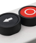 Close-up of 3 Button Industrial Control Station with up and down arrows, center stop button, in white and black housing