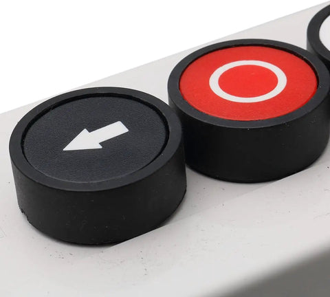 Close-up of 3 Button Industrial Control Station with up and down arrows, center stop button, in white and black housing