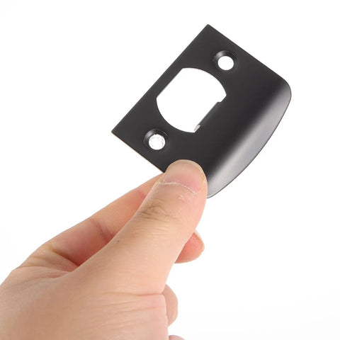 Hand holding stainless steel door strike plate black for exterior doors beefed up deadbolt reinforcement and adjustable latch restorer.