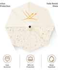 Top view of cream umbrella showcasing water droplets, illustrating fade resistance and UV protection benefits.