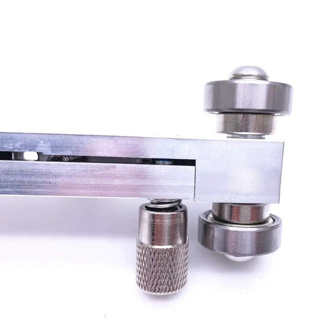 Close-up of adjustable guitar nut and bridge sander luthier tool for electric, acoustic, and bass guitars, showing aluminum body with steel rollers.