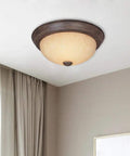 Rustic 15 Inch 3 Light Flush Mount Ceiling Fixture In Warm Mahogany With Amber Glass Shade in modern living room setting.