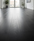 Pro Grade Black Bogwood Reactive Water Based Interior Wood Stain In A Heavy Duty 55 Gallon Drum on sleek black hardwood flooring.
