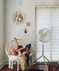 Child lounging on Boho Macrame Hammock Chair With Tassels Handwoven Cotton Rope Swing Indoor Outdoor Lounge Chair