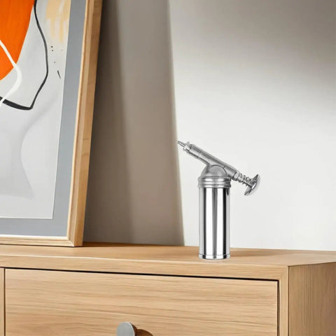 Manual 80cc Grease Gun Portable Alloy With Lock On Coupler on wooden table in workshop setting