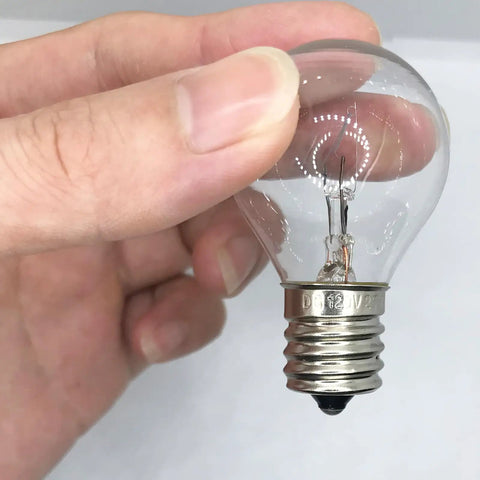Person holding S11 Shape 25 Watt E17 Intermediate Base Lava Lamp Replacement Bulb 120 Volt Dimmable 2700K Warm White