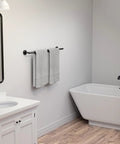 Matte Black Towel Bar 24 Inch Wall Mounted Stainless Steel Towel Rack in bathroom with towels, wall-mounted near shower.